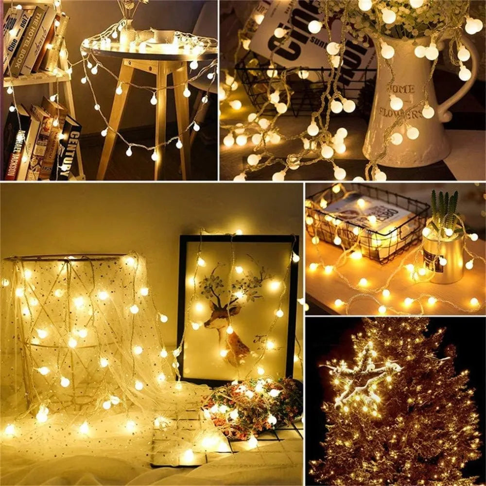 Warm white globe string lights decorating shelves, a vase, and a tabletop