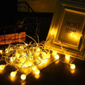 Warm white globe string lights shown as cozy room decor