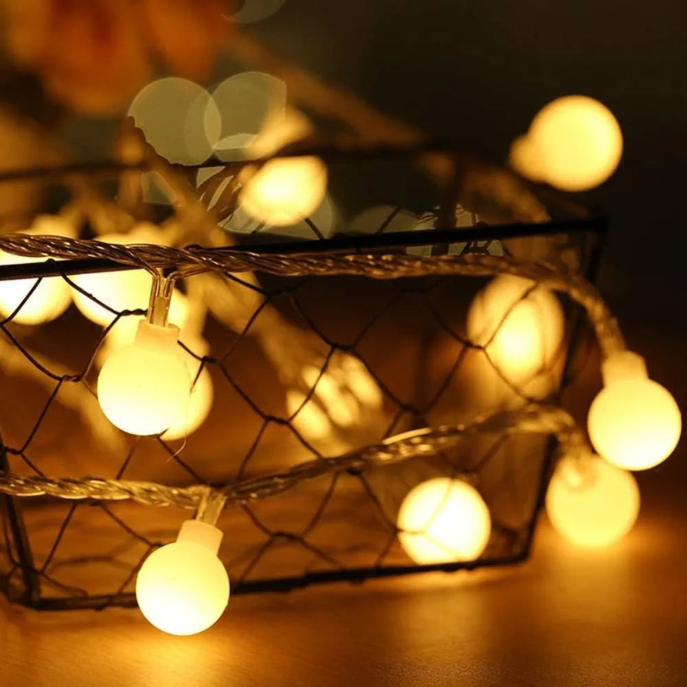 Warm white globe string lights shown as cozy room decor